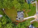 Overhead view of a private residence with a manicured lawn and a circular driveway in a wooded neighborhood at 3545 Silver Vista Ct, Cumming, GA 30041