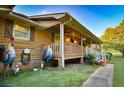 This home has a charming porch with a white railing and a well-manicured lawn at 3526 Highway 11 S, Mansfield, GA 30055