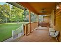 Cozy porch with seating, a ceiling fan, and a view of the beautiful yard at 3526 Highway 11 S, Mansfield, GA 30055