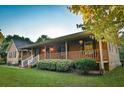 Inviting front porch with wood railing, offering a relaxing outdoor space at 3526 Highway 11 S, Mansfield, GA 30055