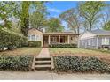 Charming bungalow with a brick walkway, front porch, and manicured landscaping at 650 Somerset Ne Ter, Atlanta, GA 30306