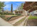 Well-maintained home features a brick driveway, landscaped yard, and inviting front porch at 650 Somerset Ne Ter, Atlanta, GA 30306
