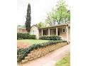 Quaint bungalow with lush landscaping, brick paver path, and covered front porch at 650 Somerset Ne Ter, Atlanta, GA 30306