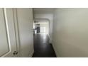 A hallway leading to an open kitchen with modern appliances at 36 S Auburn Landing Pl, Auburn, GA 30011