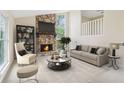 Bright living room with stone fireplace, neutral decor, and large windows offering an inviting atmosphere at 746 Polk Nw St, Marietta, GA 30064