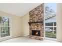 Cozy living room showcasing a stone fireplace with large windows, providing an abundance of natural light at 746 Polk Nw St, Marietta, GA 30064