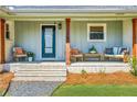 Inviting front porch with comfortable seating, brick accents, and a welcoming entrance at 2151 Blaylock Dr, Marietta, GA 30062
