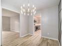 Open dining room showcasing modern lighting and seamless flow to living room and kitchen at 2544 Peyton Woods Sw Trl, Atlanta, GA 30311