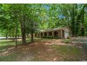 Brick home featuring an attached garage, arched front porch, and a beautifully landscaped yard at 2544 Peyton Woods Sw Trl, Atlanta, GA 30311