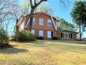 Charming two-story home with brick and siding exterior, complemented by a well-maintained front yard and mature trees at 2563 Hamill Dr, Buford, GA 30519