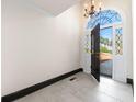 Stylish entryway with tiled floors, decorative chandelier, and a glimpse of the exterior through a glass door at 1 Mooregate Sq, Atlanta, GA 30327