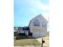 Two story home features a two car garage, manicured lawn, front shrubs, and mailbox at 116 Ventura Trl, Stockbridge, GA 30281