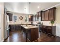 Modern kitchen featuring dark wood cabinets, granite countertops, and stainless steel appliances at 100 Marietta Walk Trce, Marietta, GA 30064