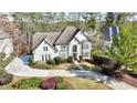 An impressive home with an appealing circular driveway, lush landscaping, and an inviting facade at 1562 Asheforde Dr, Marietta, GA 30068