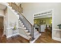 Elegant staircase with iron railings, hardwood floors, and trim details leading to the second floor at 1562 Asheforde Dr, Marietta, GA 30068