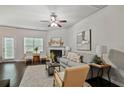 Bright living room features a ceiling fan, fireplace, neutral walls, and access to the backyard at 2359 Castle Keep Way, Atlanta, GA 30316