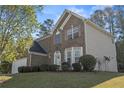 Two-story home with brick and vinyl siding, attached garage, and manicured front lawn at 3940 Medlock Park Dr, Snellville, GA 30039