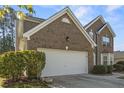 Spacious two-car garage with brick exterior and well-maintained landscaping at 3940 Medlock Park Dr, Snellville, GA 30039