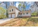 Charming home with stone accents, a covered porch, a two-car garage, and ample parking space at 5307 Mountain Village Ct, Stone Mountain, GA 30083