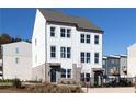 Attractive two-story townhome with white siding, a brick base, and a welcoming front entrance at 335 Skylar Se Way, Atlanta, GA 30315