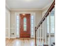 Inviting foyer featuring hardwood floors, and staircase with natural wood banister at 5611 Manassas Run, Stone Mountain, GA 30087