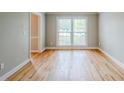 Bright living room with hardwood flooring, neutral walls, and abundant natural light at 5611 Manassas Run, Stone Mountain, GA 30087