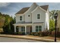 Inviting two-story home featuring a charming front porch with manicured landscaping and a welcoming entrance at 1977 Boyd Trace Nw Ln, Atlanta, GA 30318