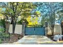 Secured driveway gate with brick columns and automatic entry, providing privacy and curb appeal at 3810 Galloway Dr, Roswell, GA 30075