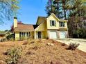 Charming two-story yellow home with a two-car garage and driveway on a sunny day at 4722 Bradford Ln, Powder Springs, GA 30127
