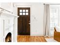 Entryway featuring hardwood floors, fireplace, and a stylish wooden front door at 955 Bouldercrest Se Dr, Atlanta, GA 30316