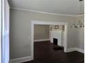 Spacious living room provides an open layout connecting to a dining area, filled with natural light at 1012 Burns Dr, Atlanta, GA 30310