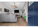 Cozy living room featuring a fireplace, vaulted ceilings, and wood-look floors at 5720 Crow Dr, Cumming, GA 30041