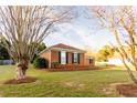 Spacious lawn featuring a low brick wall and large shade trees at 1250 Great Oaks Se Dr, Conyers, GA 30013