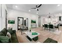 Open living room with modern decor, light wood floors, and views into kitchen and dining area at 1569 Montreat Sw Ave, Atlanta, GA 30311