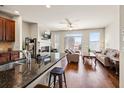 Open-concept living space with hardwood floors and fireplace and granite countertops at 4329 Tacoma Trce, Suwanee, GA 30024