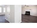 Open-concept living area with fireplace, ceiling fan, and durable flooring, blending style with functionality at 4502 Lake Park Dr, Acworth, GA 30101