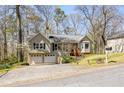 Split-level home with a two-car garage, nestled among trees in a suburban setting at 877 Old Farm Walk, Marietta, GA 30066