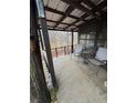 Relaxing covered porch featuring chairs and a table, ideal for enjoying the surrounding nature at 1000 Delta A15, Canton, GA 30114