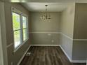 Cozy dining room with new floors, natural light, and classic chandelier at 2468 Baxter Sw Rd, Atlanta, GA 30315