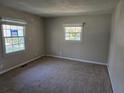 Bright bedroom featuring neutral carpet, fresh paint, and natural light from two windows at 251 Banberry Se Dr, Atlanta, GA 30315