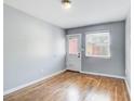 Bedroom features hardwood floors, fresh paint, and a door to the exterior at 561 Formwalt Sw St # 6, Atlanta, GA 30312