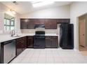 Kitchen featuring a complete black appliance package, light countertops and dark cabinetry at 332 Cheryl Ct, Jonesboro, GA 30238