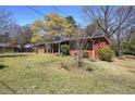 Lush lawn surrounds a single story brick home with covered front porch at 1122 Byers Sw Dr, Marietta, GA 30060
