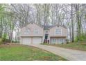 Charming two-story home featuring a two-car garage and a welcoming entrance at 3841 Greenbrook Dr, Douglasville, GA 30135