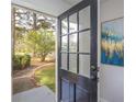Inviting front door with glass panels offering a view of the landscaped front yard at 1749 Lauranceae Way, Riverdale, GA 30296