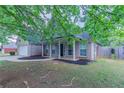 Home exterior featuring brick facade, columned porch, and manicured landscaping at 223 Gilliam Ct, Locust Grove, GA 30248