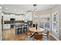Cozy kitchen with white cabinetry, granite countertops, stainless steel appliances, and adjacent breakfast nook at 2810 Burgundy Dr, Cumming, GA 30041