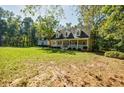 Inviting home exterior with a covered front porch, perfect for relaxing and enjoying the outdoors at 5440 Shady Grove Rd, Cumming, GA 30041