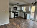 Modern kitchen with stainless steel appliances, white cabinets, and hardwood floors at 89 Paces Lakes Pt, Dallas, GA 30157