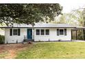 Inviting exterior showcasing a charming home with manicured lawn and lovely landscaping details at 1570 Childress Sw Dr, Atlanta, GA 30311